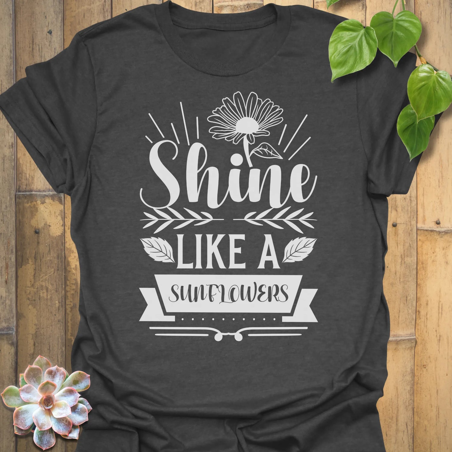 Dark Heather t-shirt featuring the design Shine Like A Sunflower printed in bold letters, sunflower lover shirt.