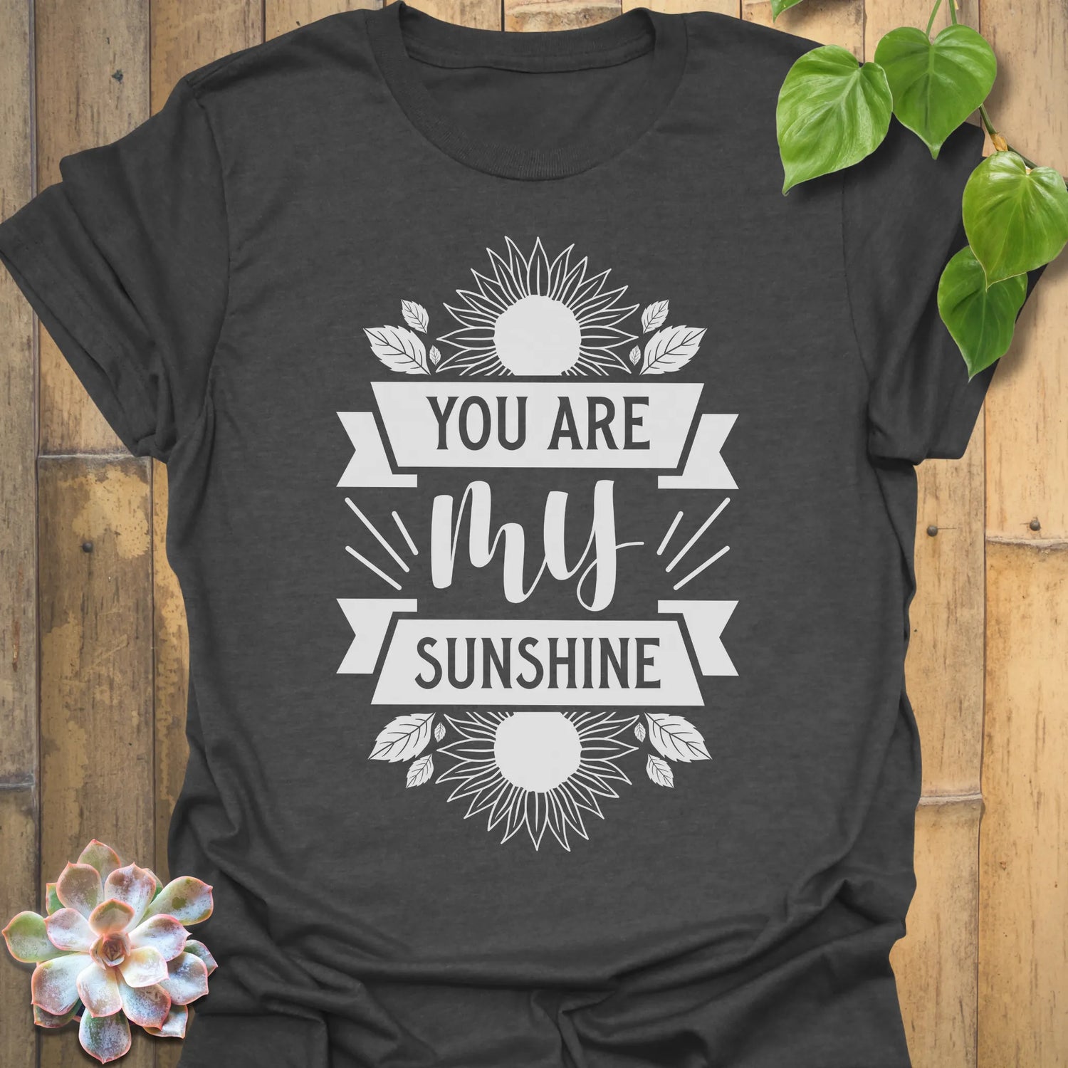 Dark Heather t-shirt featuring the design You Are My Sunshine printed in bold letters, nature-inspired graphic tee.