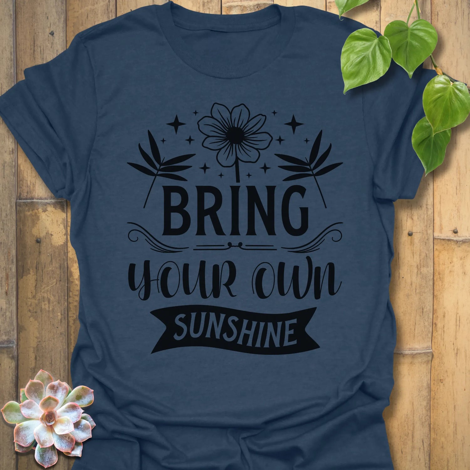 Heather Navy t-shirt featuring the design Bring Your Own Sunshine printed in bold black letters, positive vibes shirt.