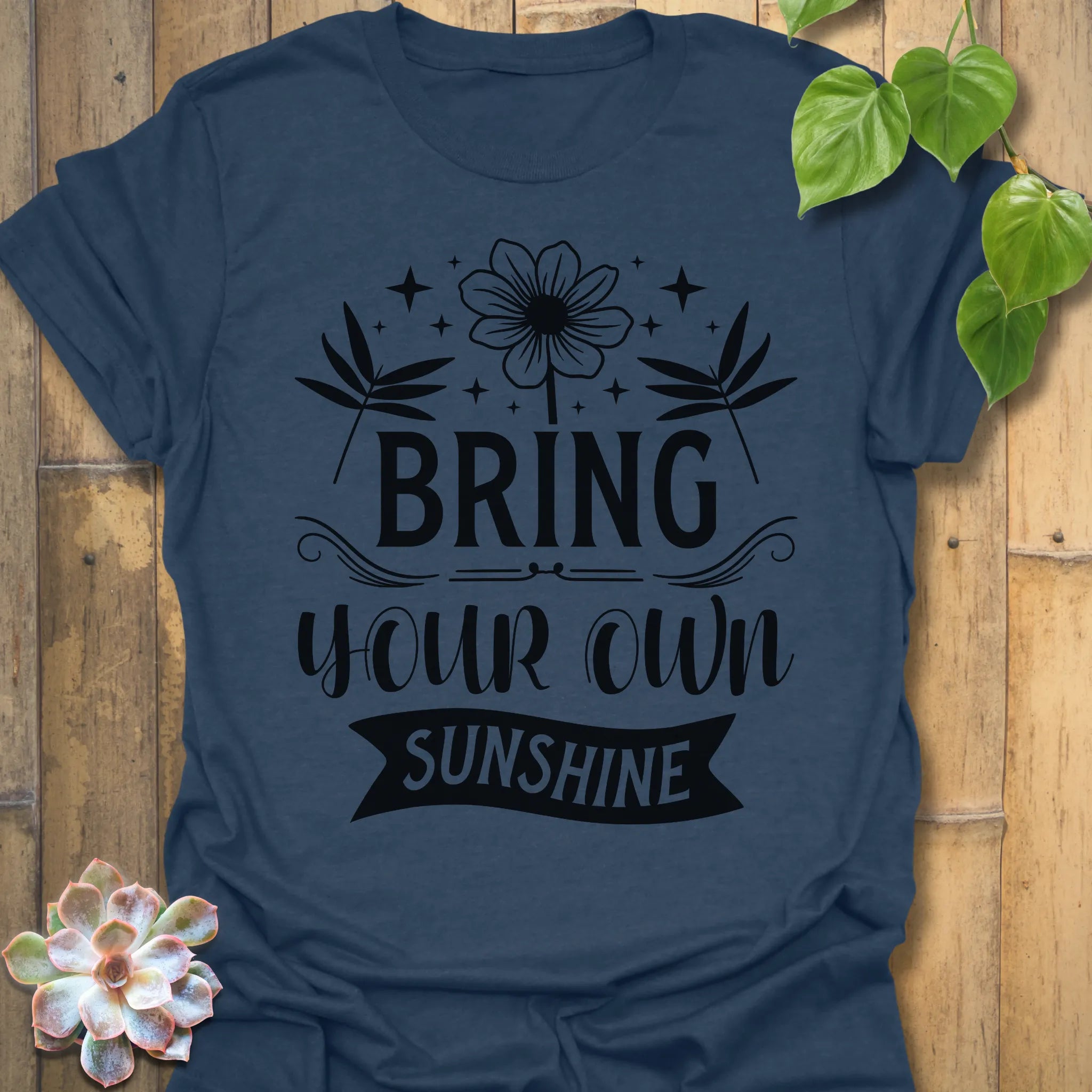 Heather Navy t-shirt featuring the design Bring Your Own Sunshine printed in bold black letters, positive vibes shirt.