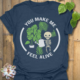 Heather Navy t-shirt featuring the design Feel Alive printed in bold white letters with plants, motivational graphic tee.
