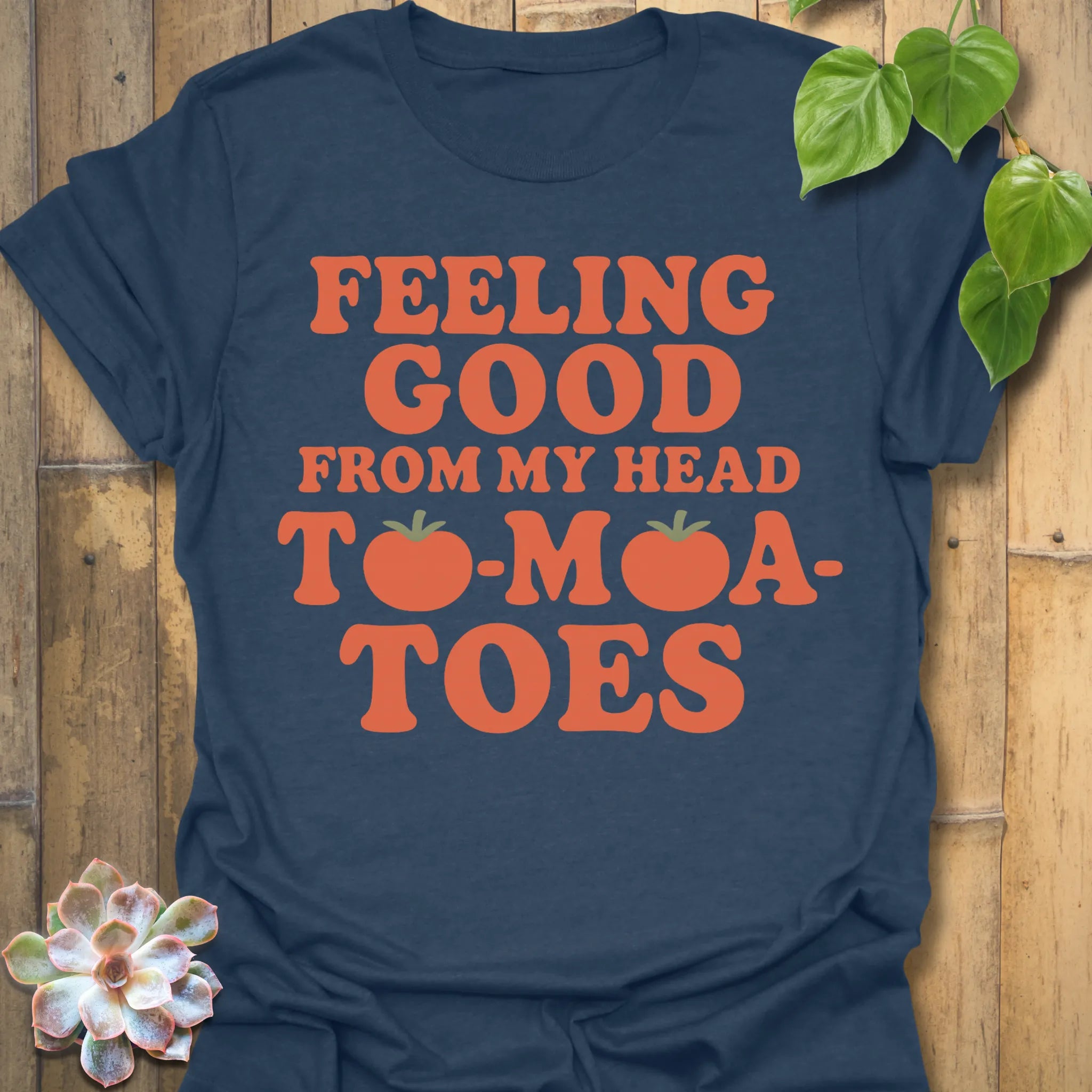 Heather Navy t-shirt featuring the design Feeling Good printed in bold orange letters, feel-good graphic shirt.