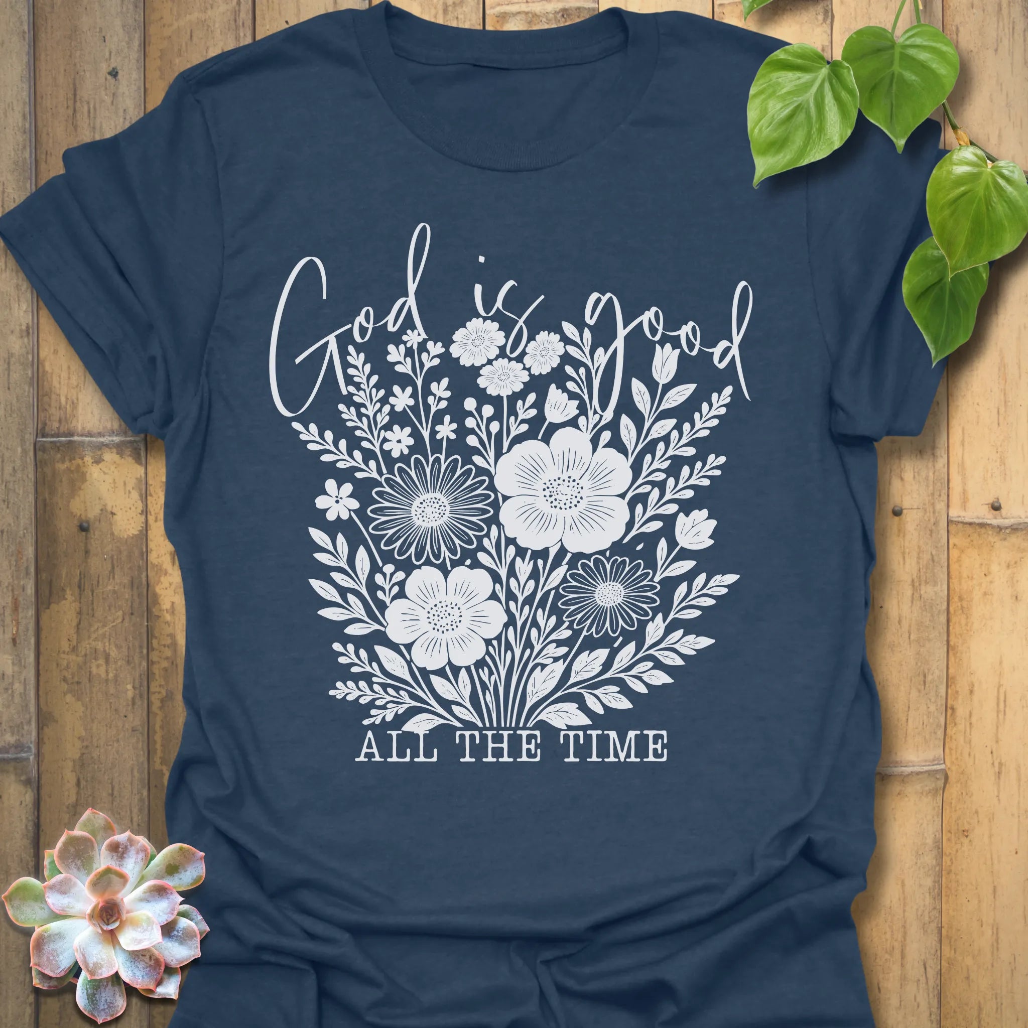 Heather Navy t-shirt featuring the design God Is Good printed in black letters, religious faith shirt.