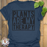 Heather Navy t-shirt featuring the design Plants Are My Therapy printed in bold letters, plant lover shirt.