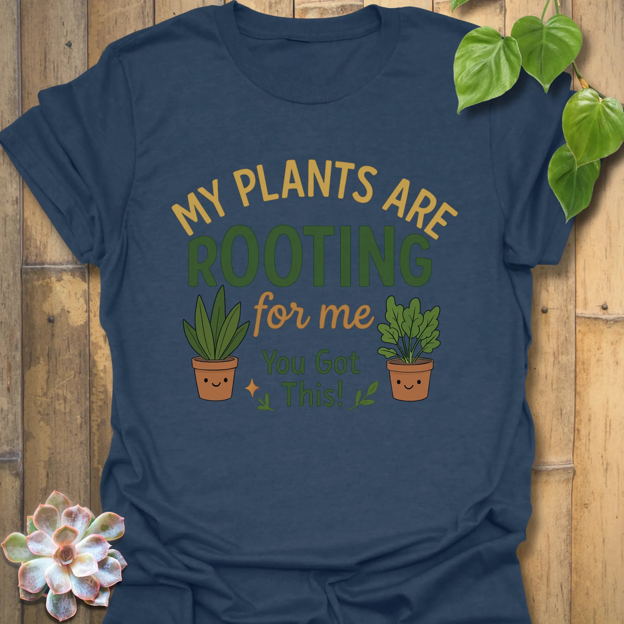 Heather Navy t-shirt featuring the design Plants Are Rooting printed in bold letters, gardening graphic tee.