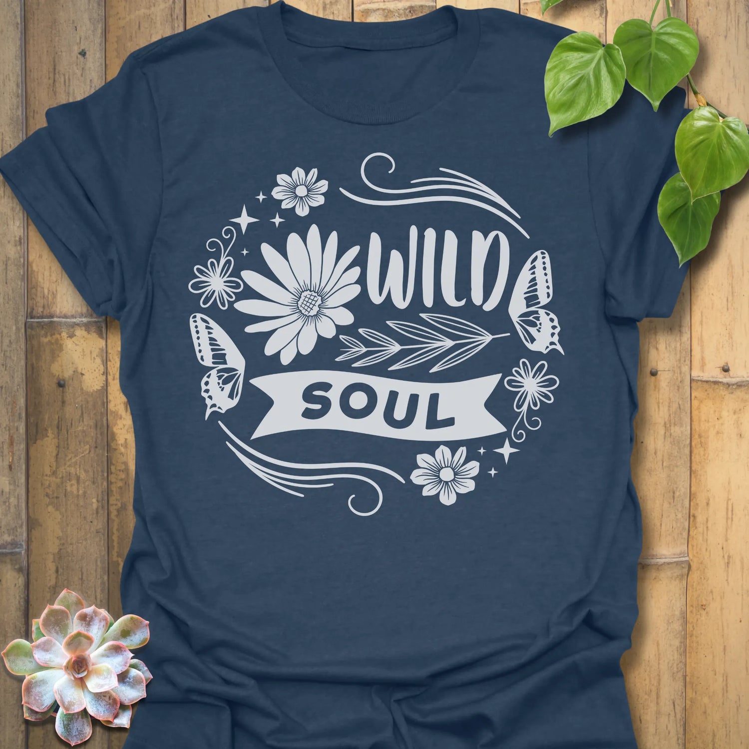 Heather Navy t-shirt featuring the design Wild Soul printed in bold black letters, floral graphic tee.