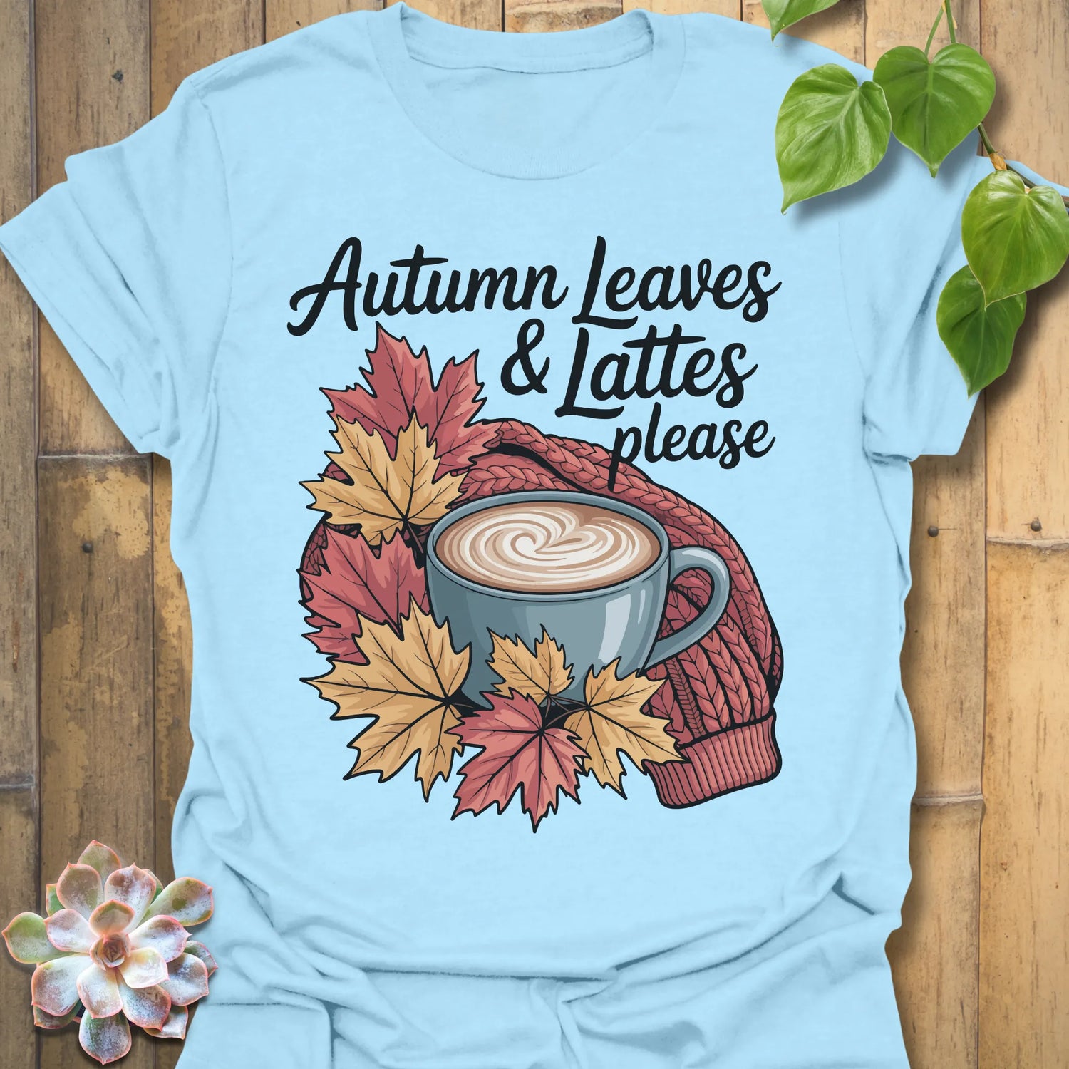Light Blue t-shirt featuring the design Autumn Leaves &amp; Lattes printed in cosy fall shirt for coffee lovers.