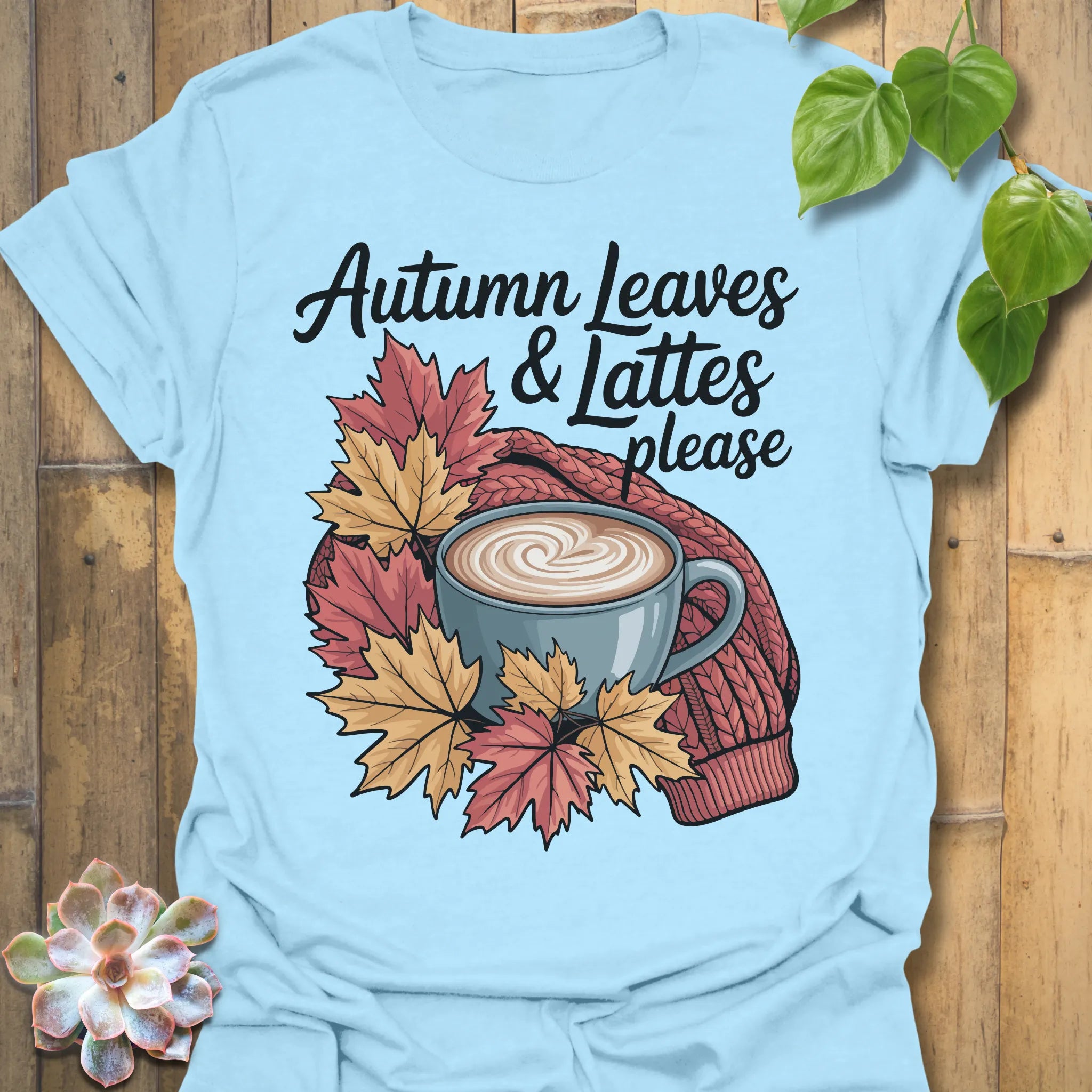 Light Blue t-shirt featuring the design Autumn Leaves &amp; Lattes printed in cosy fall shirt for coffee lovers.