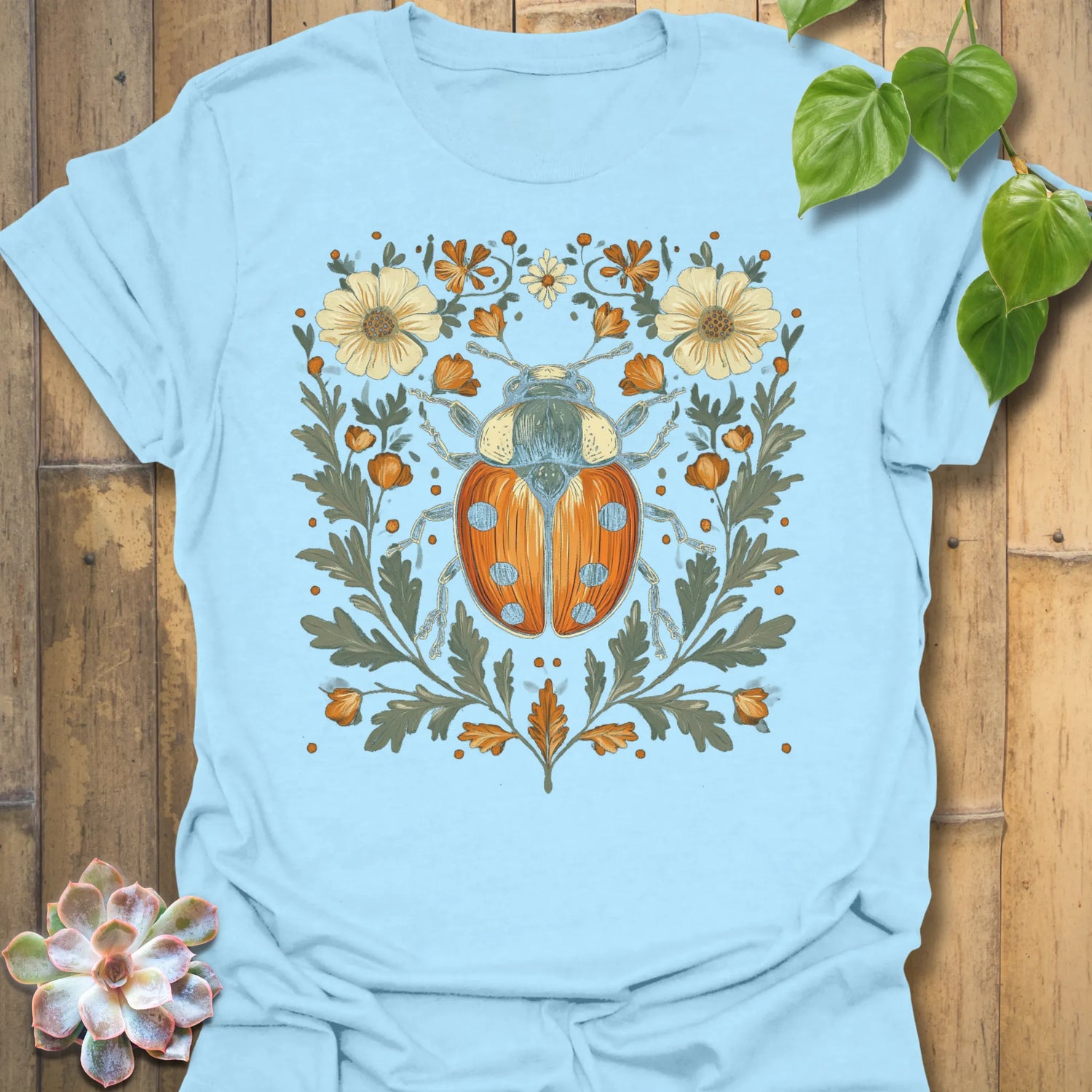 Light Blue t-shirt featuring the design Blossom Beetle printed in nature-inspired floral beetle shirt.