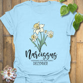 Light Blue t-shirt featuring the design December Narcissus with a detailed narcissus flower illustration, ideal for a nature-inspired botanical tee