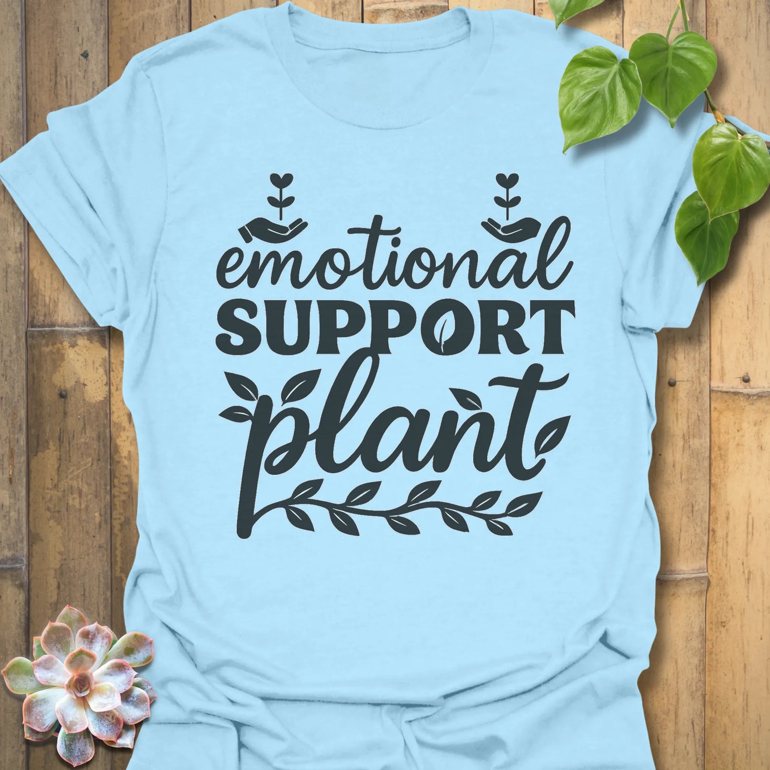 Light Blue t-shirt featuring the design Emotional Support printed in bold letters, plant wellness graphic shirt.