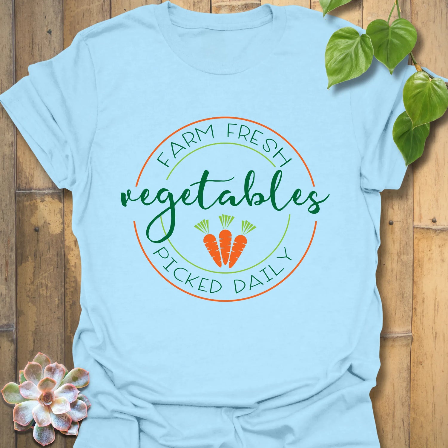 Light Blue t-shirt featuring the design Farm Fresh Vegetables Picked Daily with illustrated vegetables, fresh produce graphic tee.