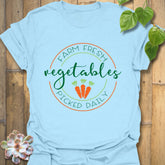 Light Blue t-shirt featuring the design Farm Fresh Vegetables Picked Daily with illustrated vegetables, fresh produce graphic tee.
