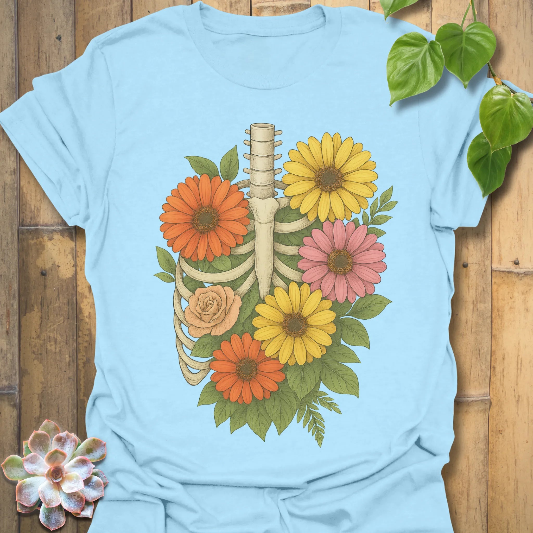 Light Blue t-shirt featuring the design Gerbera Bones printed in floral skeleton graphic tee.