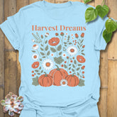Light Blue t-shirt featuring the design Harvest Dreams printed in bold orange letters, cosy harvest tee.