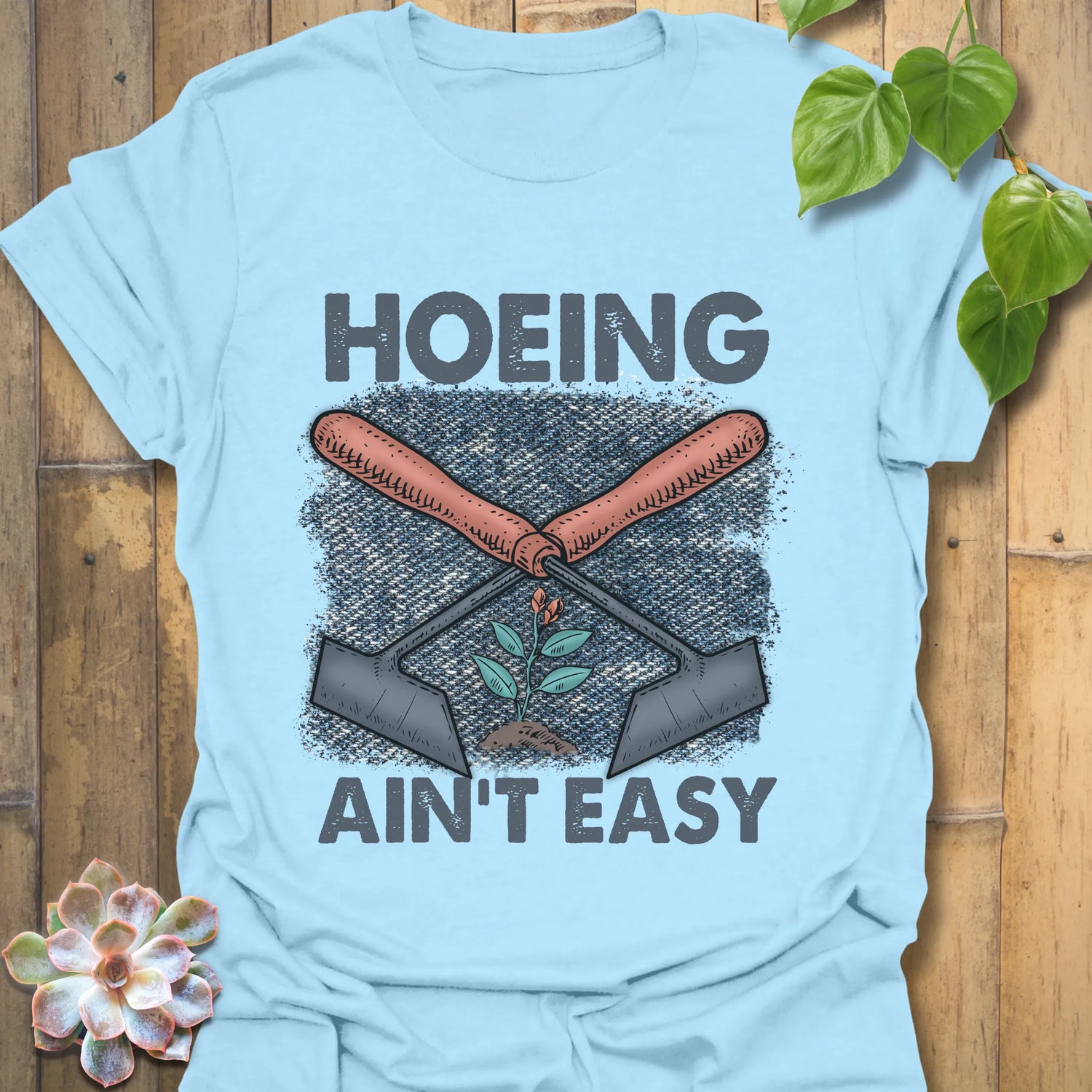 Light Blue t-shirt featuring the design Hoeing Ain’t Easy, funny plant lover t-shirt.