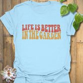 Light Blue t-shirt featuring the design Life is better in the garden printed in green floral lettering, nature-inspired garden lover shirt