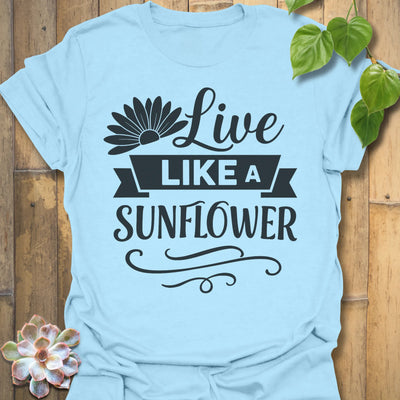 Light Blue t-shirt featuring the design Live Like A Sunflower printed in bold black letters, sunflower lover shirt.