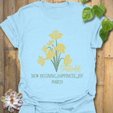 Light Blue t-shirt featuring the design March Daffodil with a print of flower Rose, a soft pastel floral shirt.