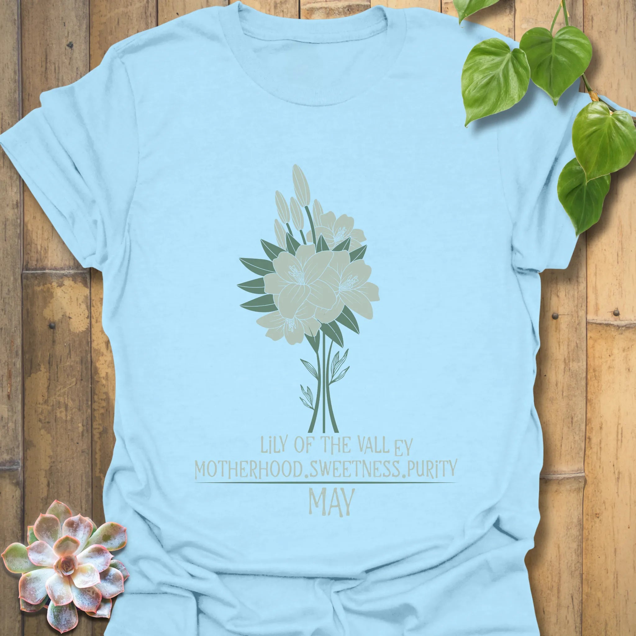 Light Blue t-shirt featuring the design May Lily of the Valley with Rose flower print, a stylish floral graphic tee for everyday wear.