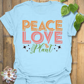 Light Blue t-shirt featuring the design Peace Love Plant printed in bold letters, gardening lover shirt.