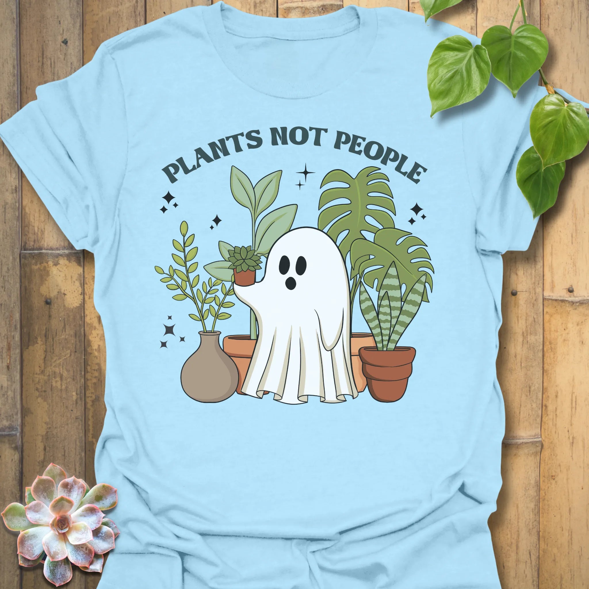 Light Blue t-shirt featuring the design Plants Not People printed in bold white letters, halloween plant lover graphic tee.