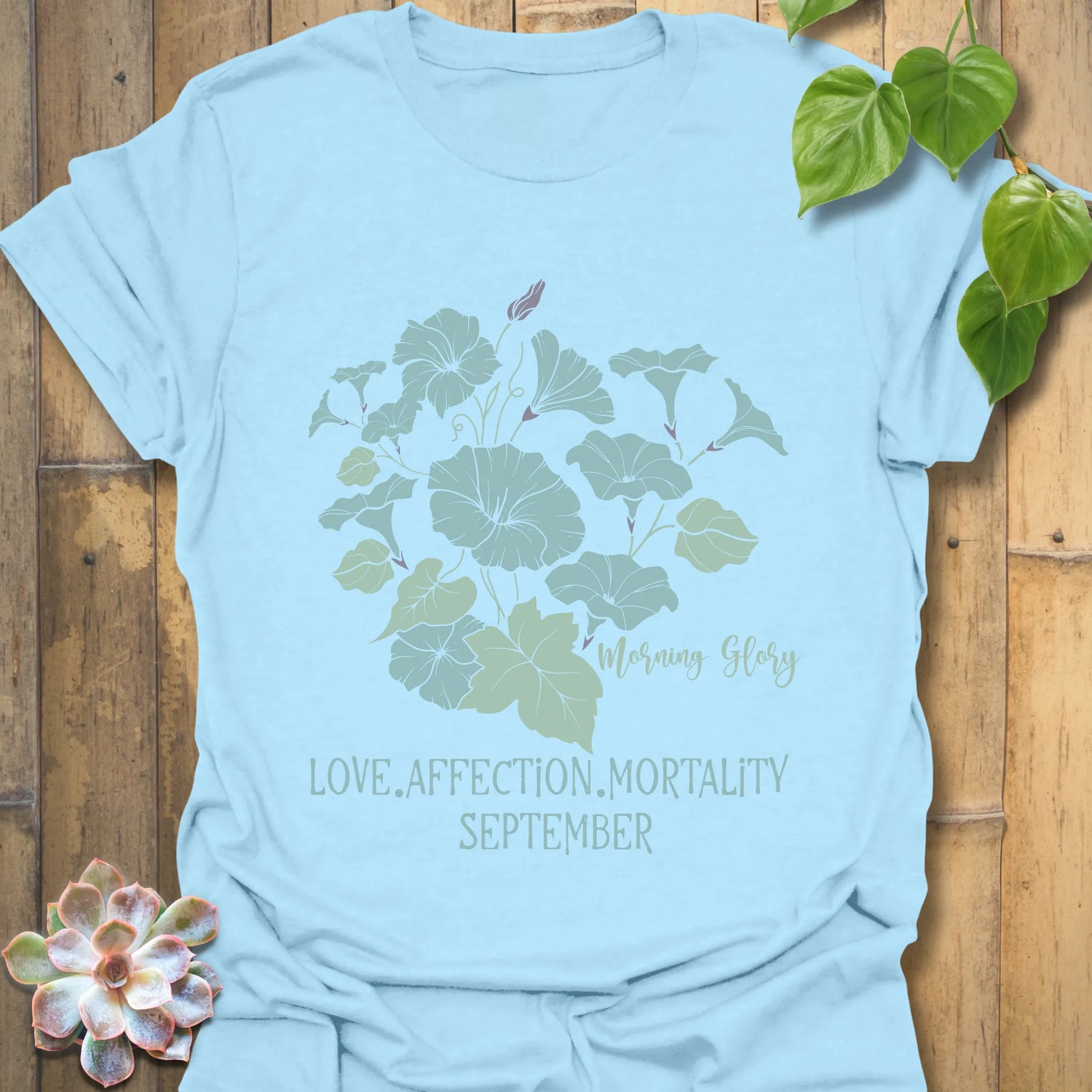 Light Blue t-shirt featuring the design September Morning Glory with a flower print, a vibrant botanical graphic tee ideal for spring and summer.
