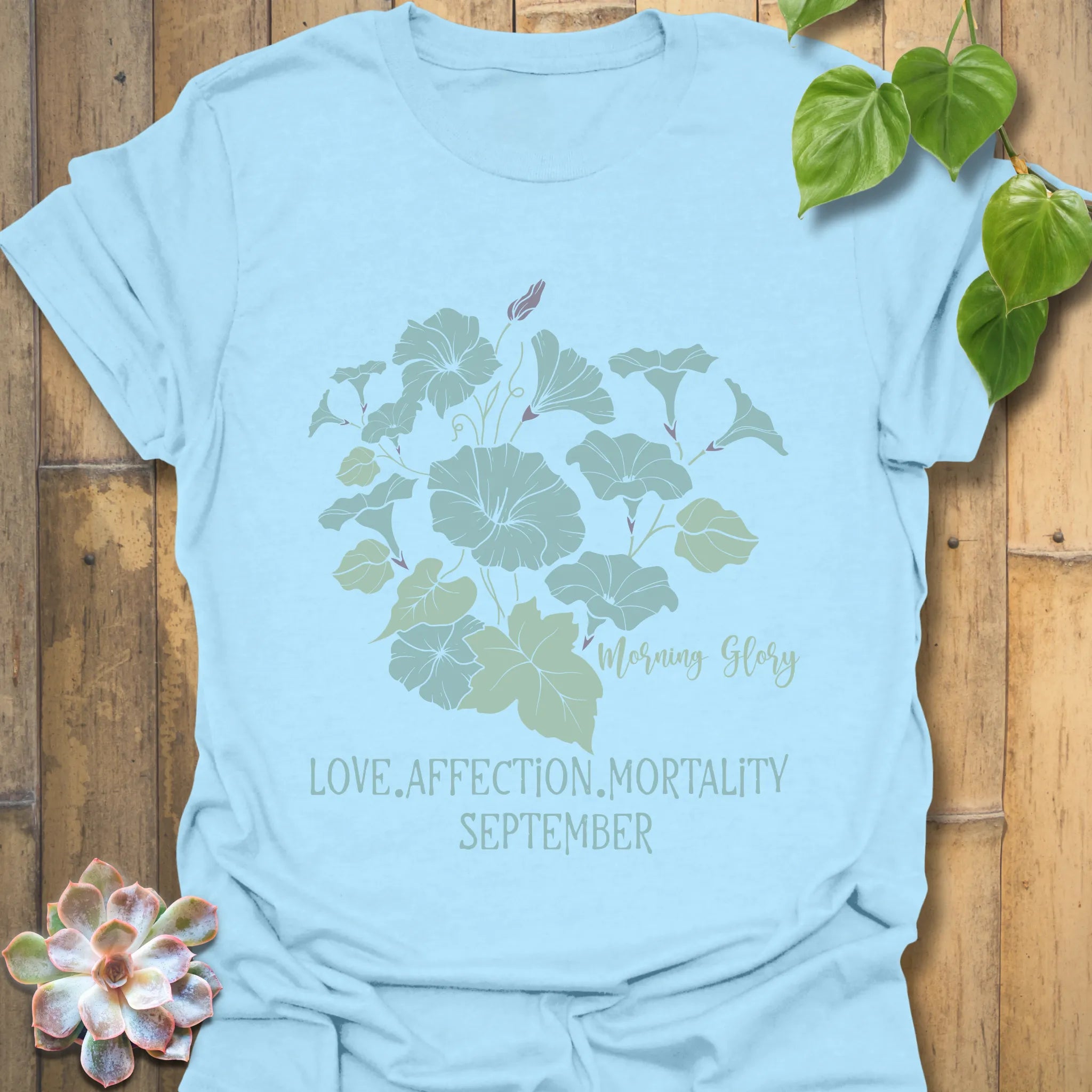 Light Blue t-shirt featuring the design September Morning Glory with a flower print, a vibrant botanical graphic tee ideal for spring and summer.