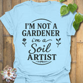Light Blue t-shirt featuring the design Soil Artist printed in bold letters, funny garden shirt.