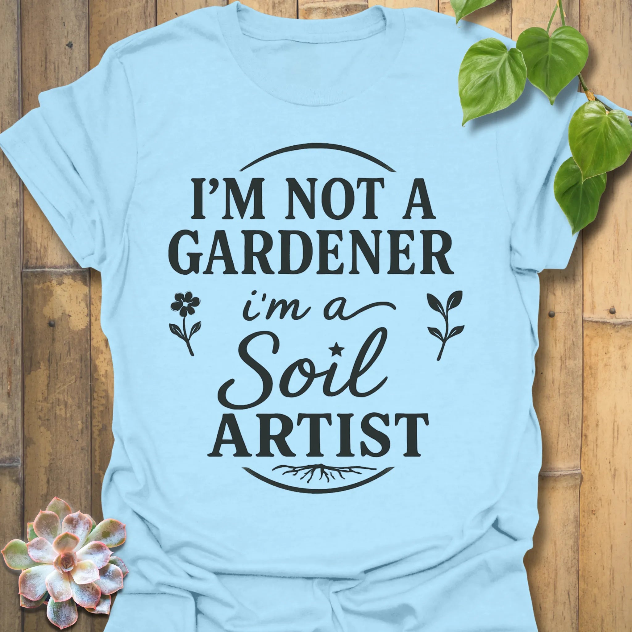 Light Blue t-shirt featuring the design Soil Artist printed in bold letters, funny garden shirt.