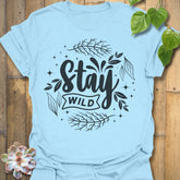 Light Blue t-shirt featuring the design Stay Wild printed in bold white letters, floral graphic lover shirt.