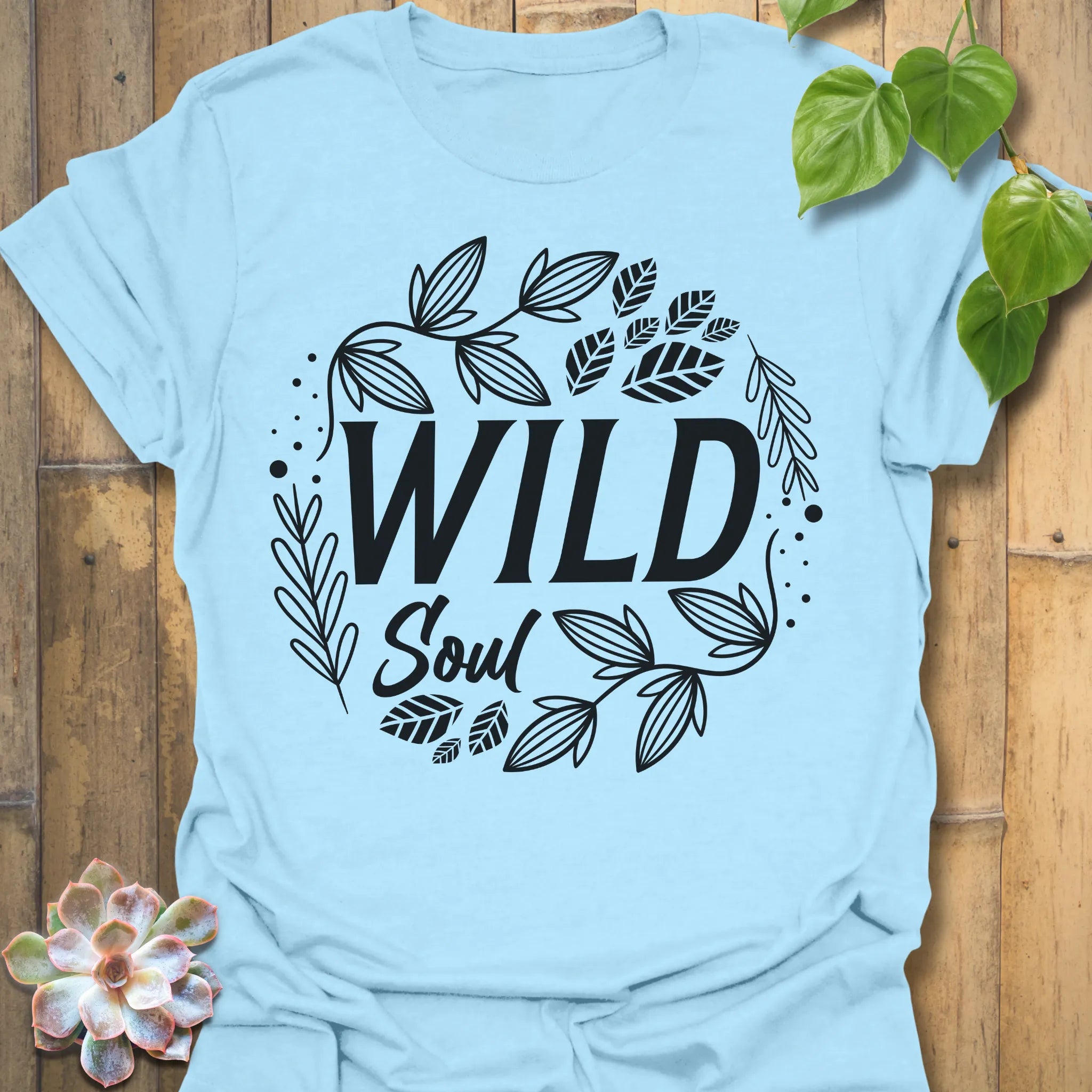 Light Blue t-shirt featuring the design Wild Soul printed in bold white letters, nature-inspired shirt.