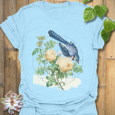 Light blue t-shirt featuring the Botanical Flight design with a bird and flower print
