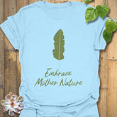 Light blue t-shirt featuring the text “Embrace Mother Nature” alongside a green leaf print