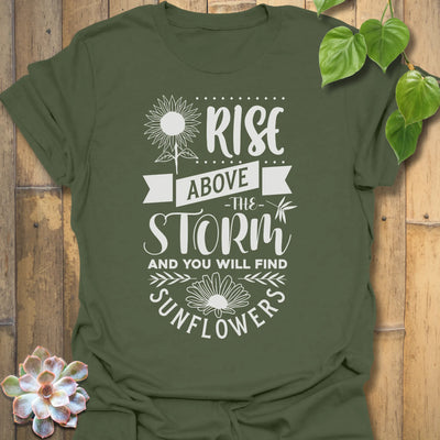 Military Green t-shirt featuring the design Above The Storm printed in bold letters, floral inspirational sunflower graphic shirt.