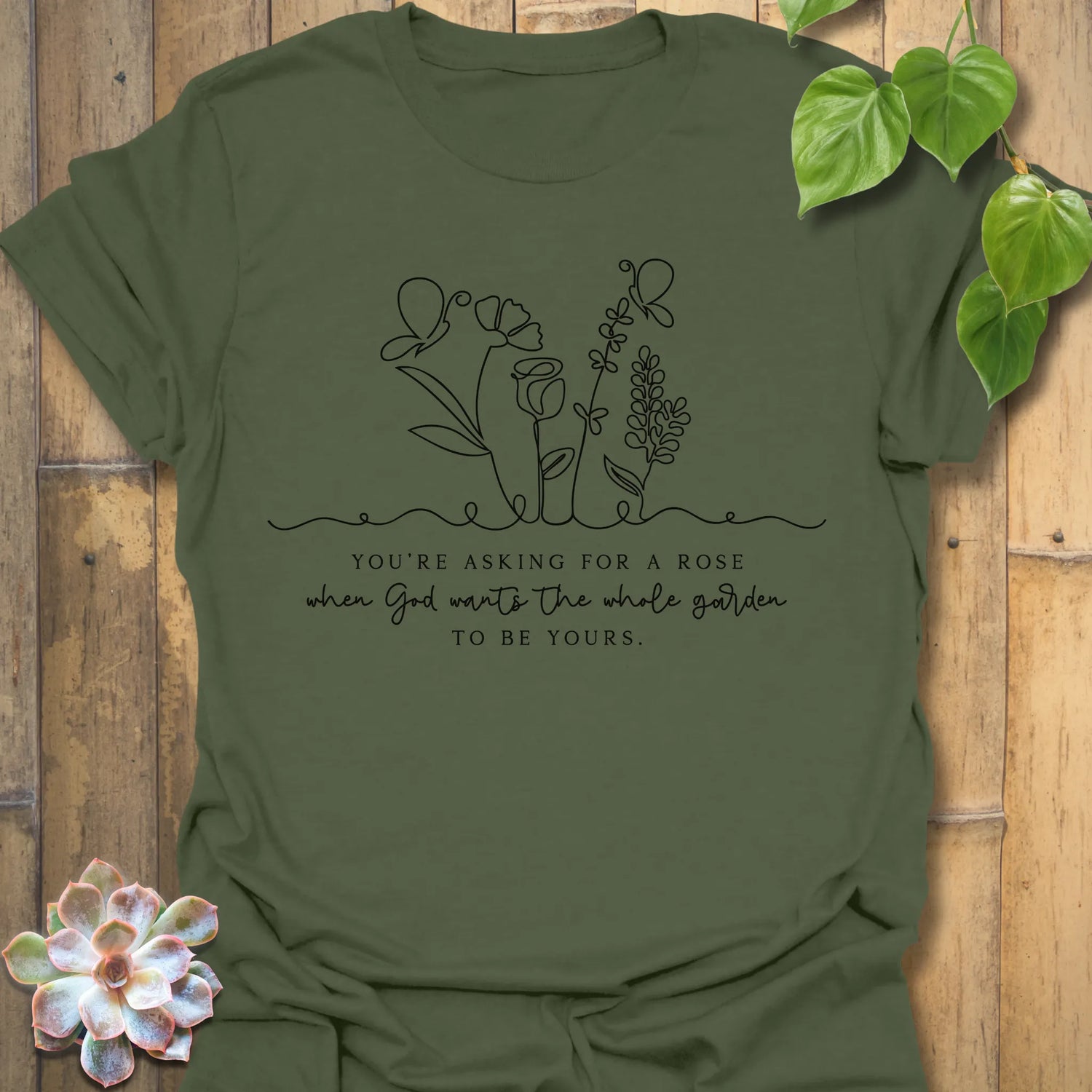 Military Green t-shirt featuring the design Asking For A Rose printed in black letters and flowers, floral humour shirt.