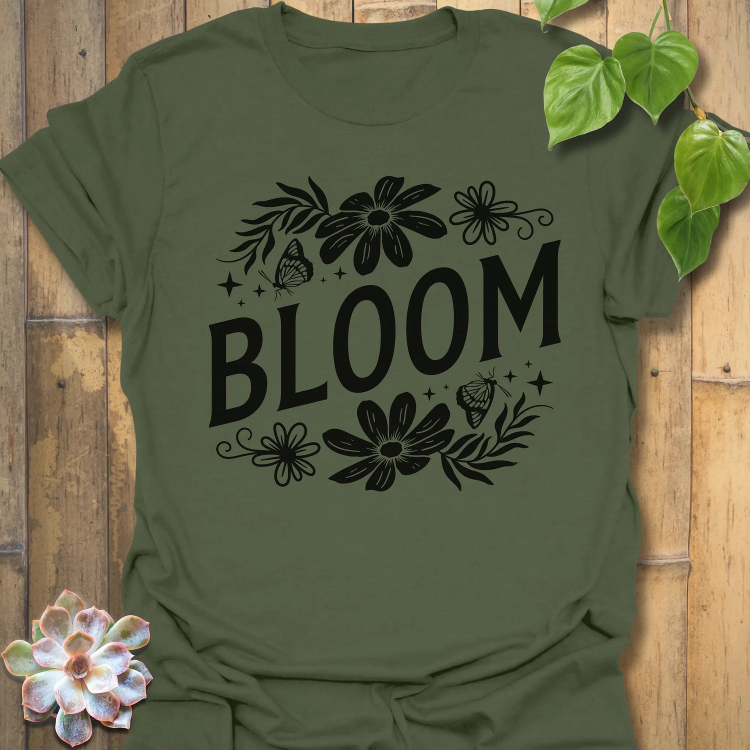 Military Green t-shirt featuring the design Bloom printed in bold black letters, floral graphic tee for plant lovers.