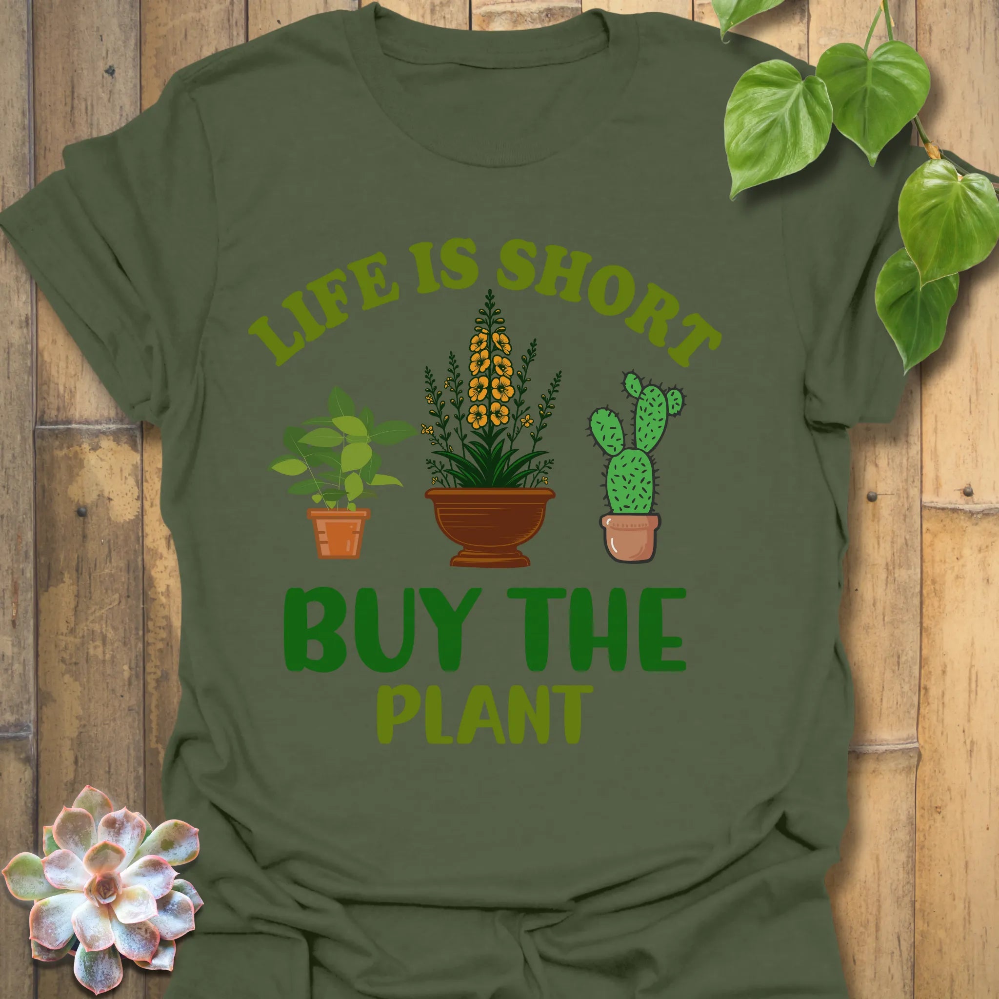 Military Green t-shirt featuring the design Buy The Plant printed in bold letters, funny gardening shirt.