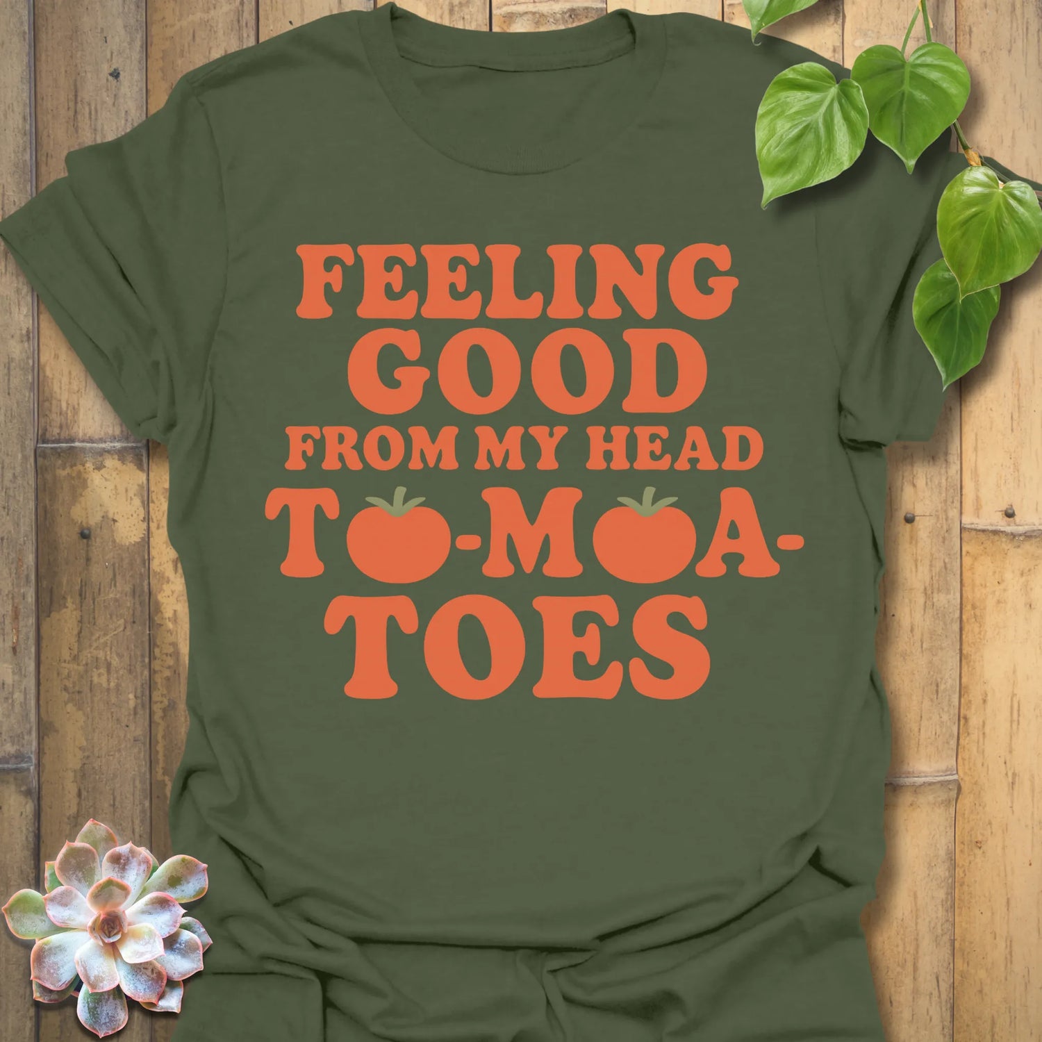 Military Green t-shirt featuring the design Feeling Good printed in bold orange letters, feel-good graphic shirt.