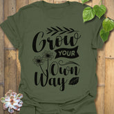 Military Green t-shirt featuring the design Grow Your Own Way printed in bold black letters, positive garden shirt