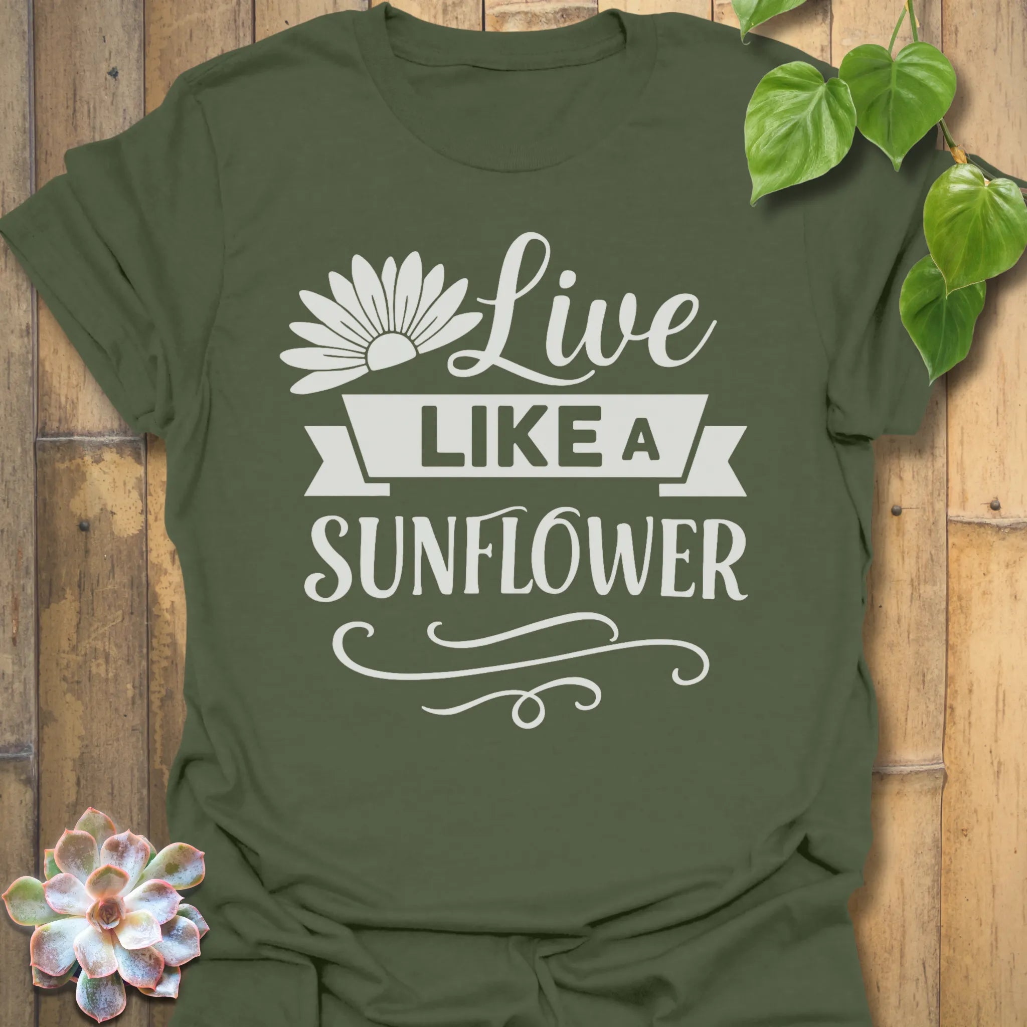 Military Green t-shirt featuring the design Live Like A Sunflower printed in bold black letters, sunflower lover shirt.