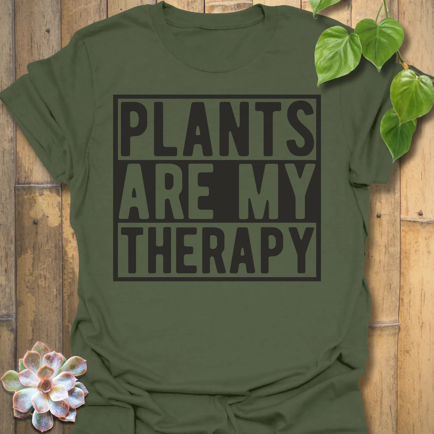 Military Green t-shirt featuring the design Plants Are My Therapy printed in bold letters, plant lover shirt.