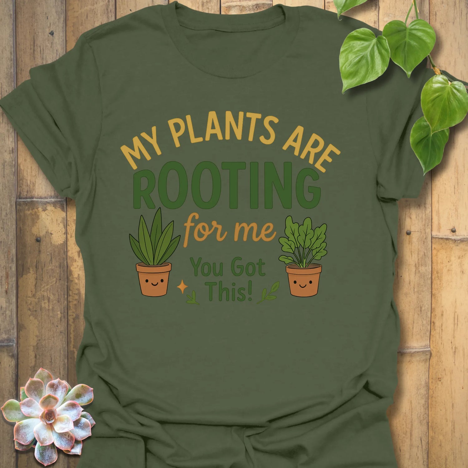 Military Green t-shirt featuring the design Plants Are Rooting printed in bold letters, gardening graphic tee.