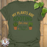 Military Green t-shirt featuring the design Plants Are Rooting printed in bold letters, gardening graphic tee.