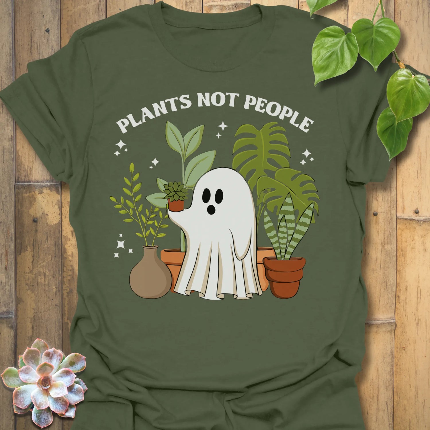 Military Green t-shirt featuring the design Plants Not People printed in bold white letters, halloween plant lover graphic tee.