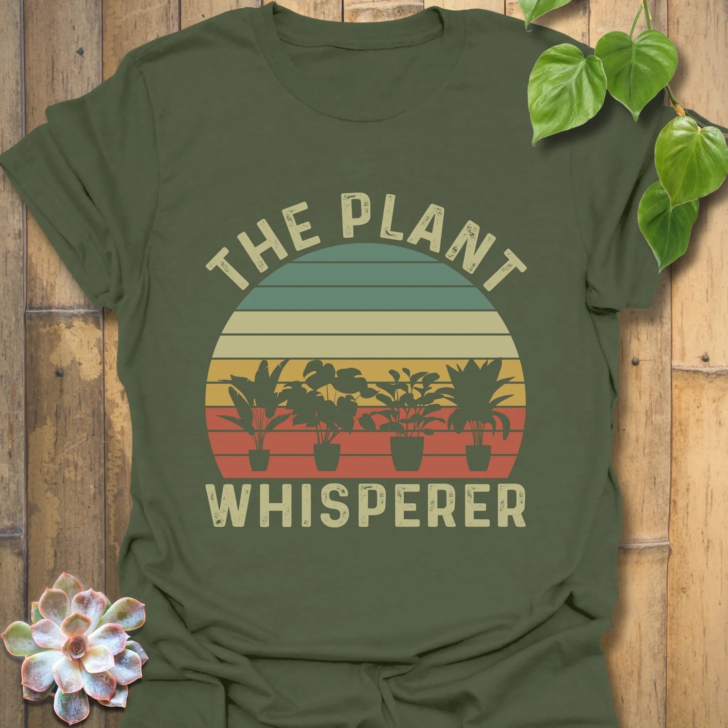Military Green t-shirt featuring the design The Plant Whisperer with a plant in a pot, a stylish gift for gardening and nature lovers.