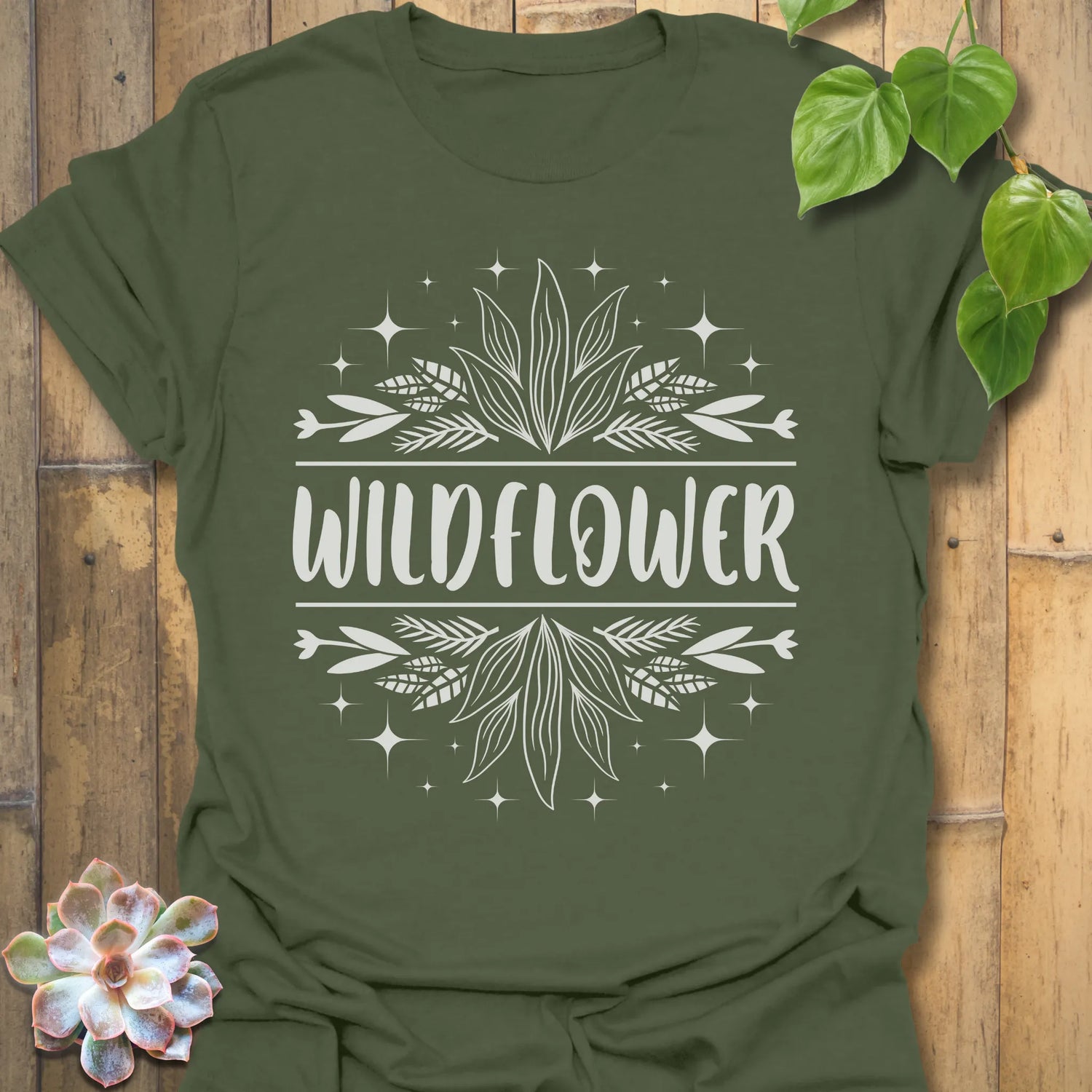 Military Green t-shirt featuring the design Wildflower printed in bold white letters, floral graphic shirt.