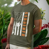 Military green American flag garden t-shirt featuring the design Gardener with a vertical word, plant, and watering sprinkler print, ideal for proud gardeners