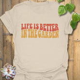 Natural t-shirt featuring the design Life is better in the garden printed in green floral lettering, eco-friendly gardening tee for outdoor enthusiasts