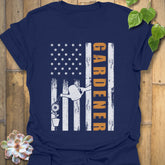 Navy gardener gift shirt featuring the design Gardener with a vertical word, American flag, plant, and watering sprinkler print for gardening enthusiasts